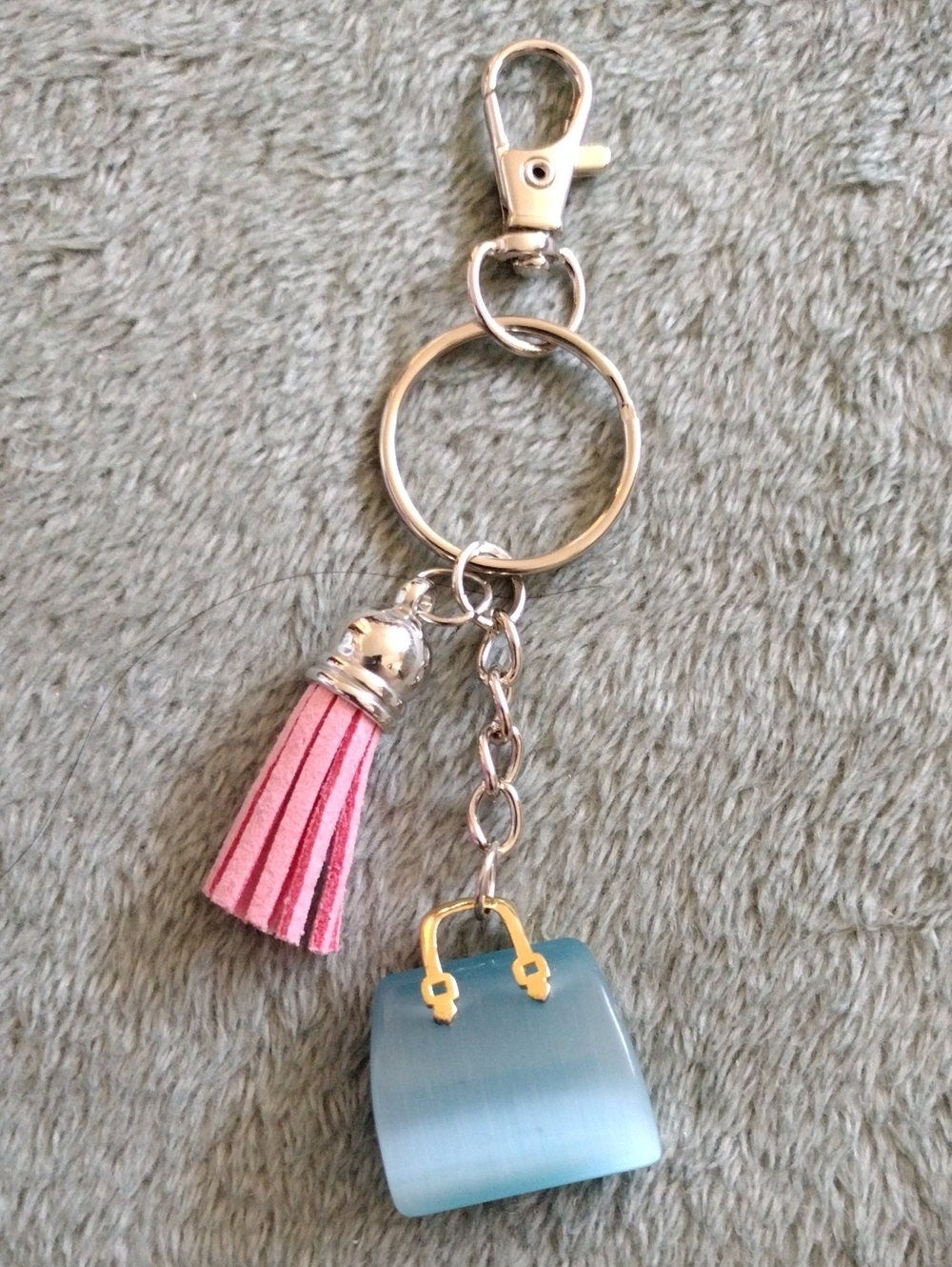 Blue Gemstone Handbag With A Pink Tassel Keychain